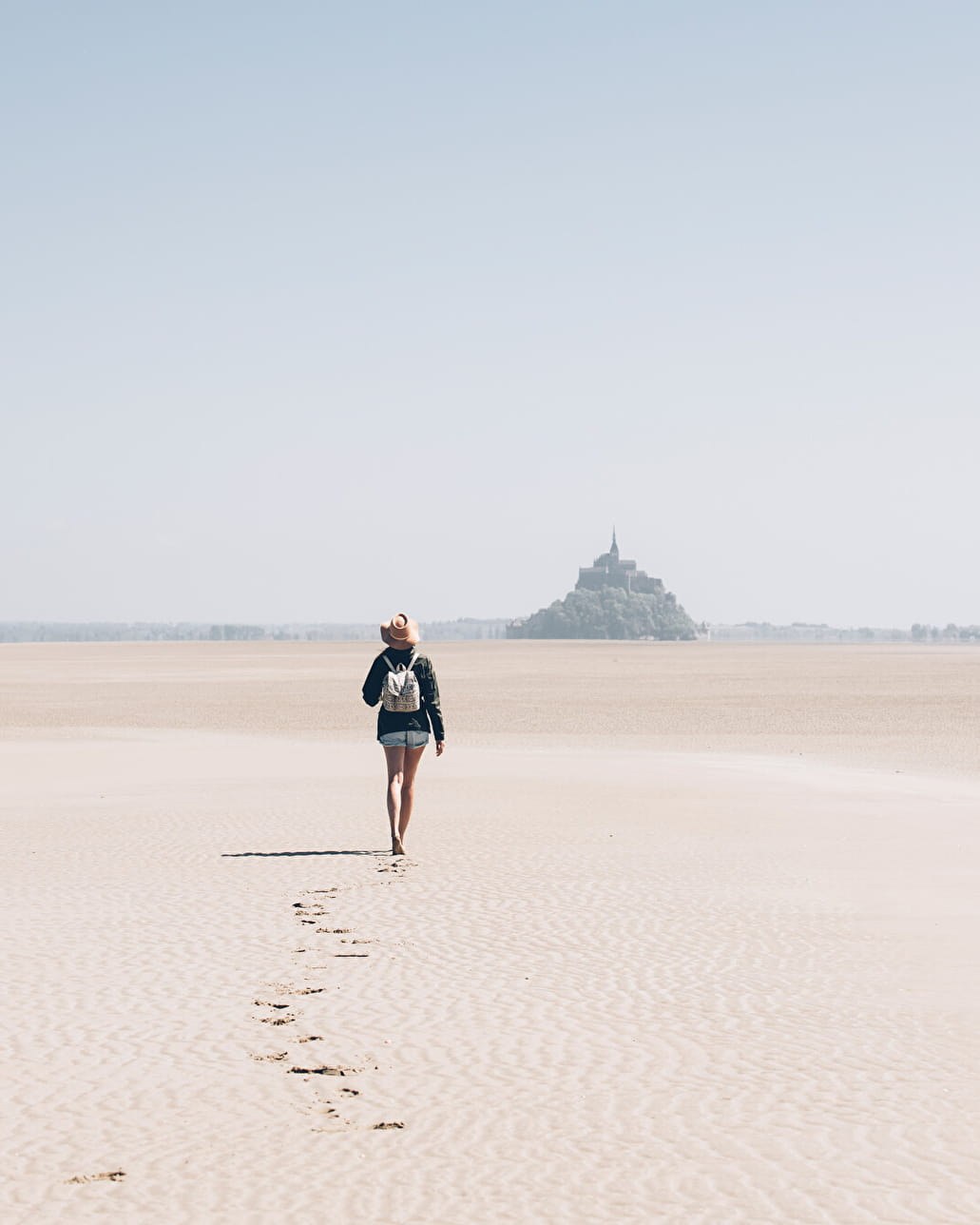 People crossing the bay of Mont-Saint-Michel at low tide